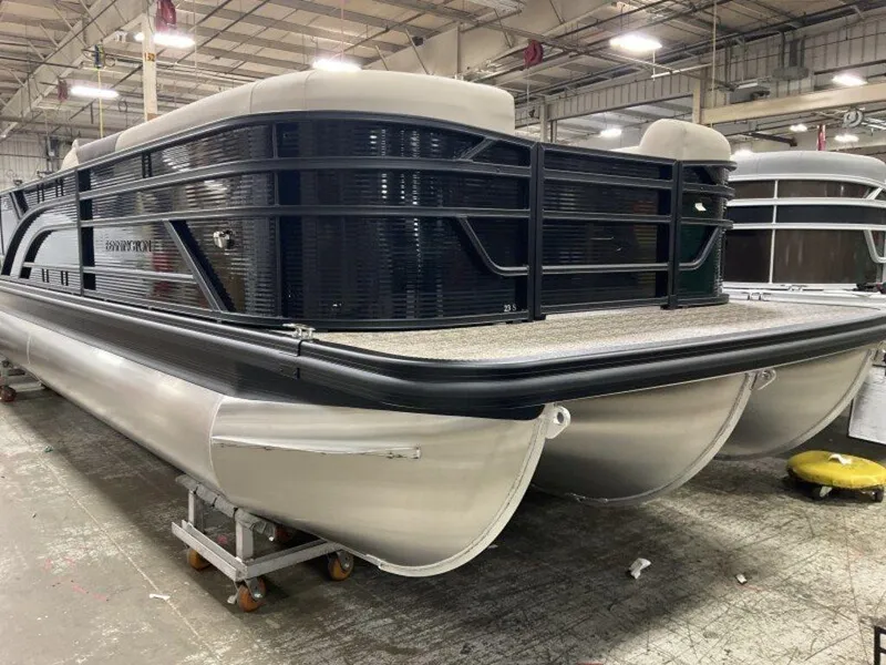 Slide: The Image of 2025 Bennington 23 SL pontoon boat in a warehouse setting. - 10