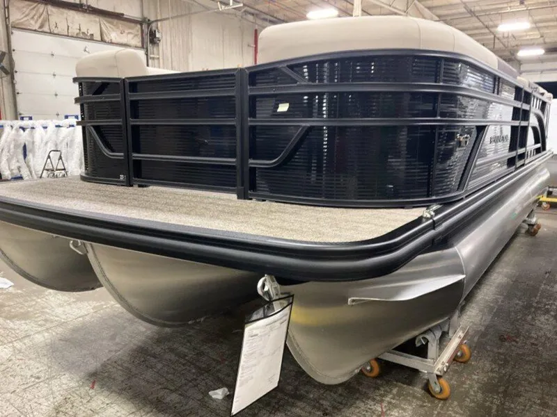 Slide: The Image of 2025 Bennington 23 SL pontoon boat in a warehouse setting. - 11