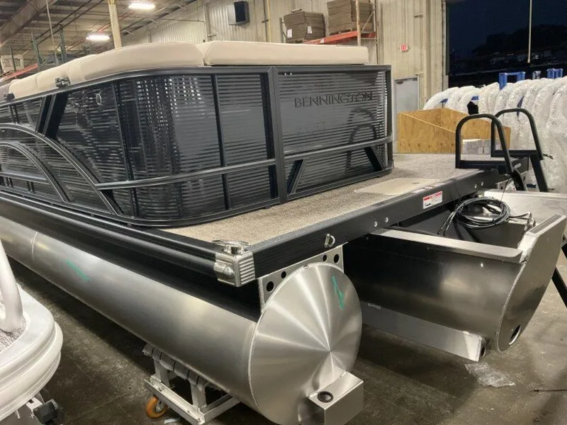 Slide: The Image of 2025 Bennington 23 SL pontoon boat in a warehouse setting. - 13
