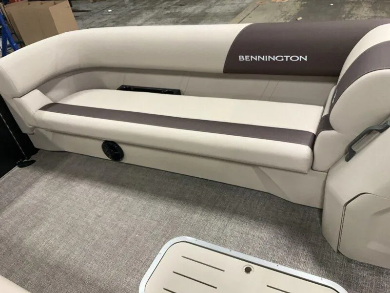 Slide: The Image of 2025 Bennington 23 SL boat interior with beige seating and carpeted flooring. - 15
