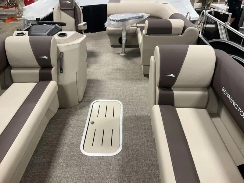 Slide: The Image of 2025 Bennington 23 SL pontoon boat interior with beige and brown seating. - 16