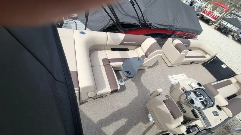 Slide: The Image of 2025 Bennington 23 SL pontoon boat interior with beige seating and steering console. - 21