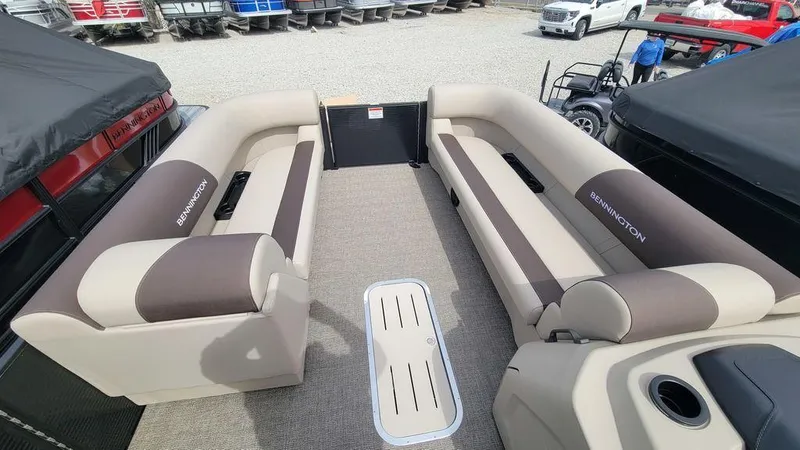 Slide: The Image of 2025 Bennington 23 SL pontoon boat interior with beige and brown seating. - 3
