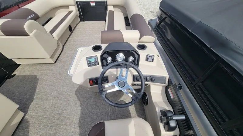 Slide: The Image of 2025 Bennington 23 SL boat interior with steering wheel and seating area. - 4