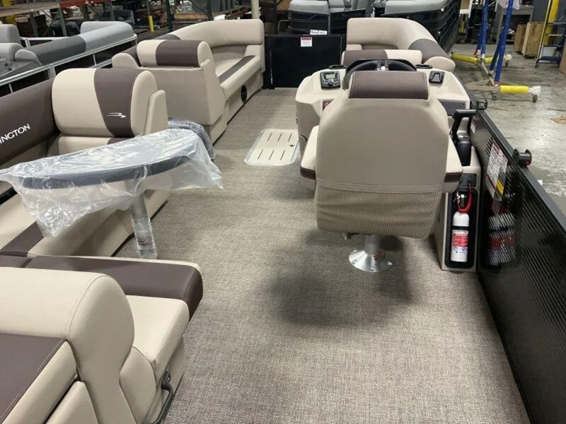 Slide: The Image of 2025 Bennington 23 SL pontoon boat interior with beige seating and steering console. - 6
