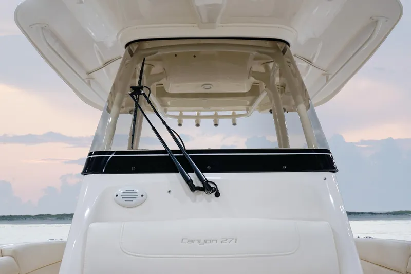 Slide: The Image of 2025 Grady-White Canyon 271 boat, front view at sunset, showcasing sleek design and windshield. - 7