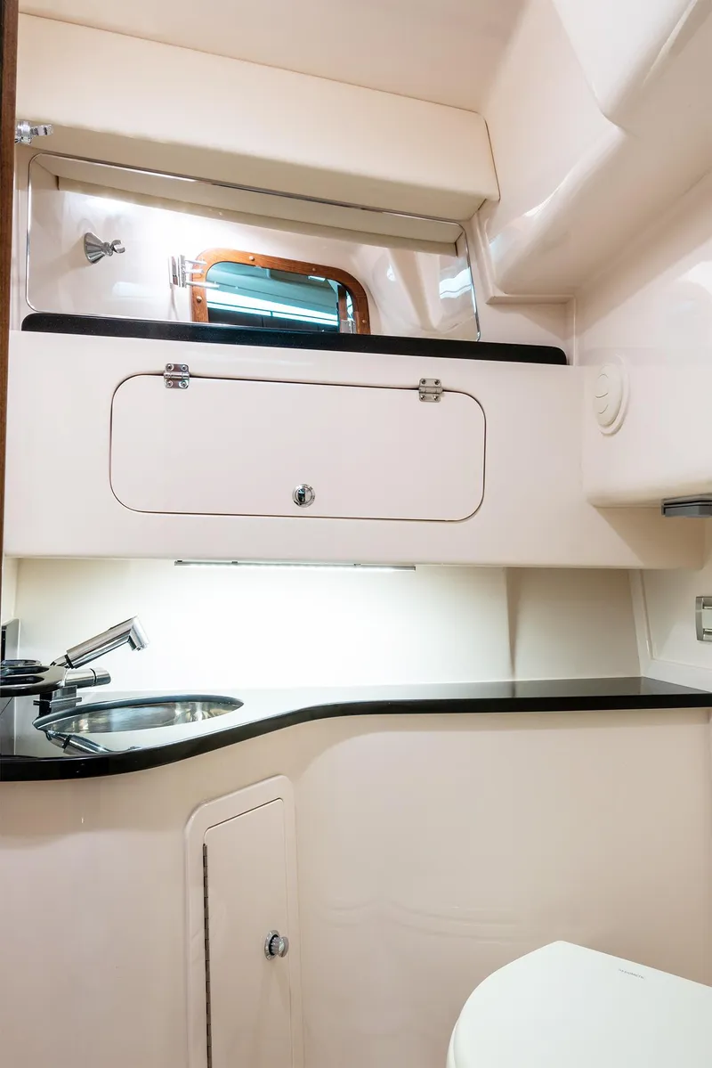 Slide: The Image of 2025 Grady-White 330 Express boat interior with modern sink and storage. - 15