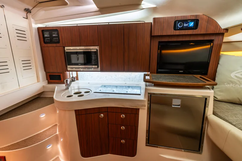 Slide: The Image of Luxurious 2025 Grady-White 330 Express yacht interior with modern kitchen amenities. - 17