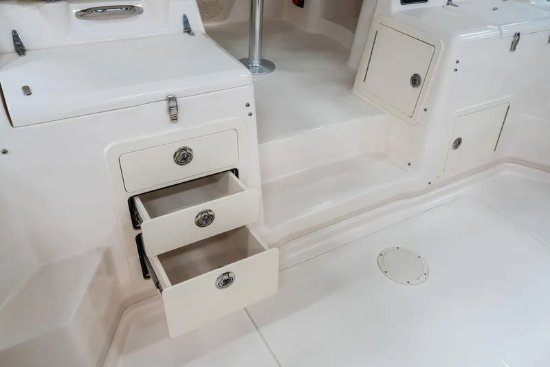 Slide: The Image of 2025 Grady-White 330 Express boat interior with open storage drawers. - 7