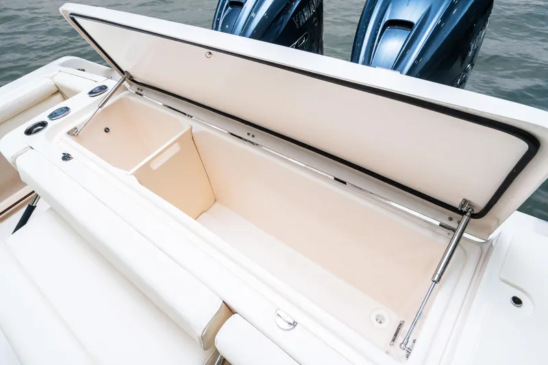 Slide: The Image of 2025 Grady-White 330 Express boat storage compartment with open lid, showcasing spacious interior. - 9