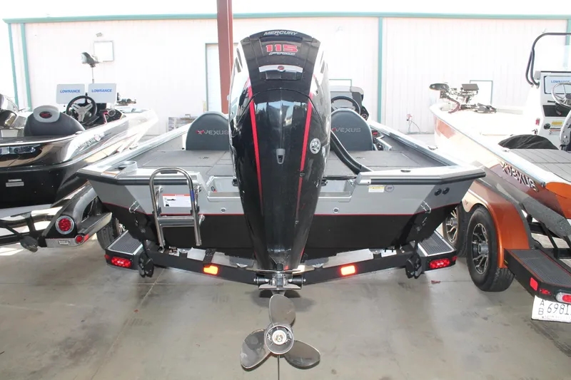 Slide: The Image of 2025 Vexus AVX1880 boat with Mercury 115 outboard motor in showroom. - 14