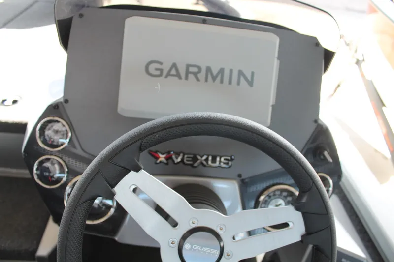 Slide: The Image of 2025 Vexus AVX1880 boat dashboard with Garmin display and steering wheel. - 20