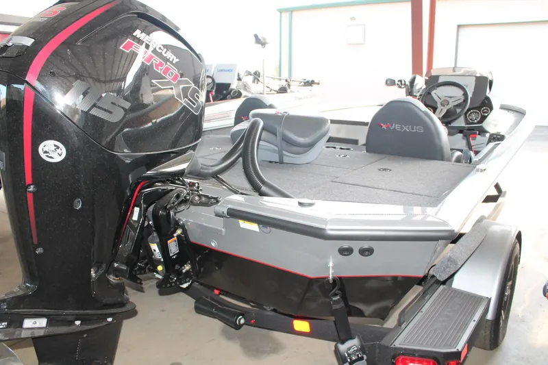 Slide: The Image of 2025 Vexus AVX1880 boat with Mercury Pro XS 115 engine in a garage setting. - 3