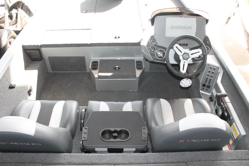 Slide: The Image of 2025 Vexus AVX1880 boat interior with Garmin dashboard and dual seating. - 4