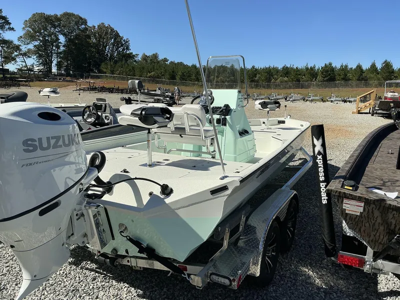 Slide: The Image of 2025 Excel Bay Pro 220 Elite boat with Suzuki engine in outdoor setting. - 5