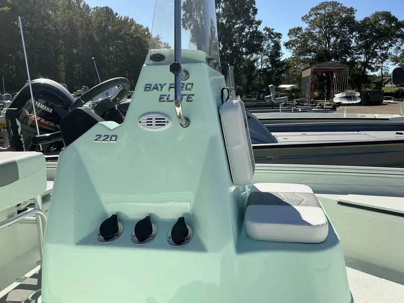 Slide: The Image of 2025 Excel Bay Pro 220 ELITE boat console with seating, outdoors. - 6