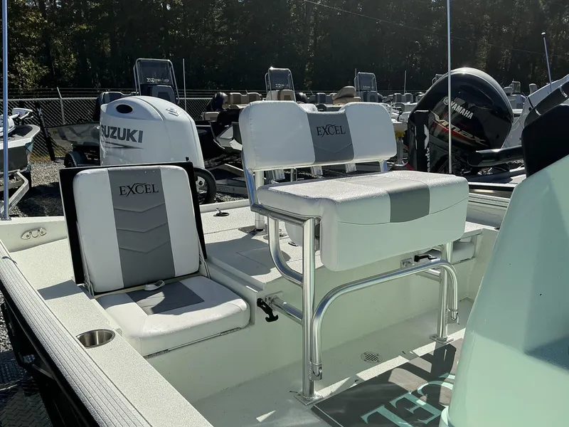 Slide: The Image of 2025 Excel Bay Pro 220 ELITE boat interior with seating and motor details. - 8