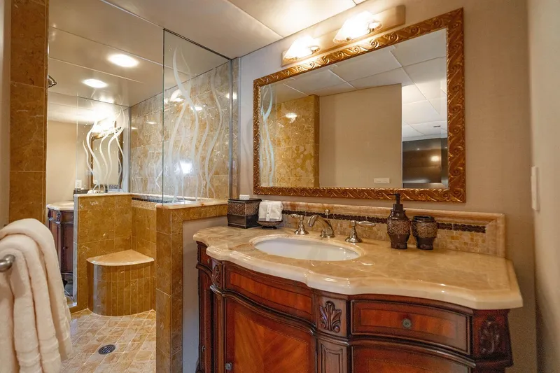 Slide: The Image of Luxurious bathroom on 2009 Custom Crystal Motoryacht with elegant wood vanity and glass shower. - 130