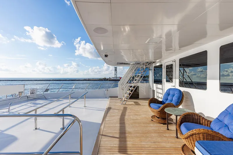 Slide: The Image of Deck of a 2009 Custom Crystal Motoryacht with blue chairs. - 48