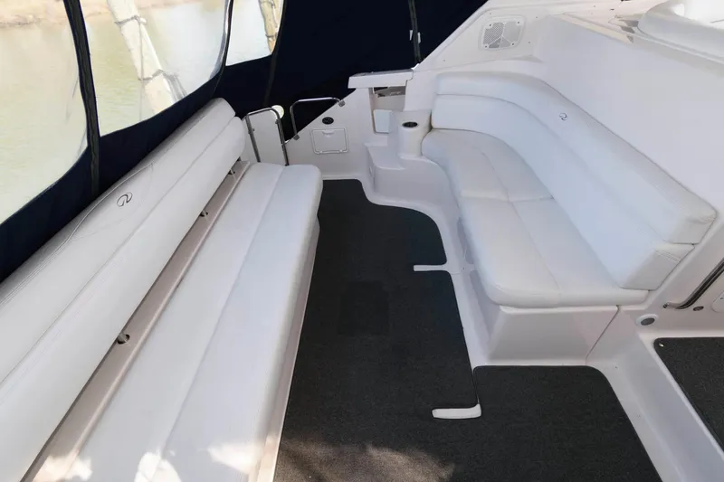 Slide: The Image of 2006 Regal 4460 Commodore boat interior with white seating and dark carpet. - 11