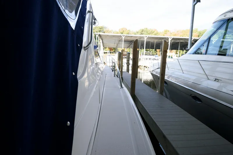 Slide: The Image of 2006 Regal 4460 Commodore yacht docked beside a marina walkway. - 14