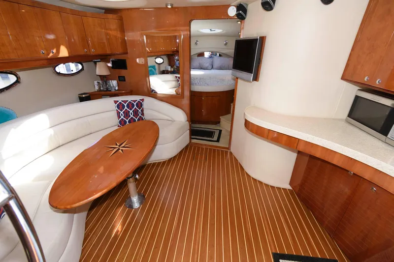 Slide: The Image of Luxurious interior of 2006 Regal 4460 Commodore yacht with wood flooring and modern amenities. - 15