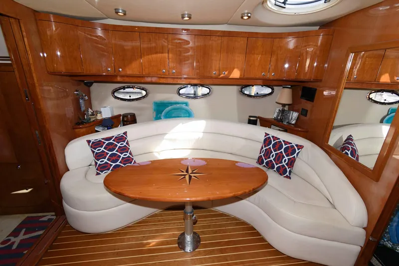 Slide: The Image of Luxurious interior of 2006 Regal 4460 Commodore yacht with elegant seating and wooden finishes. - 16