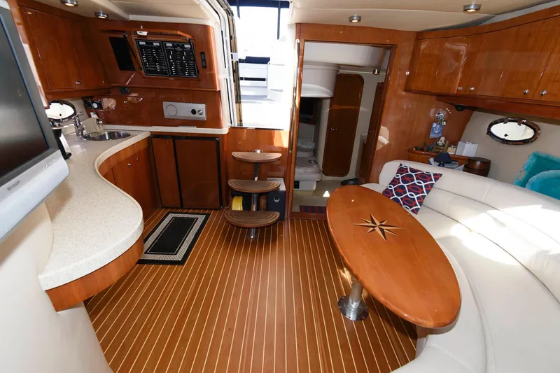 Slide: The Image of Interior of 2006 Regal 4460 Commodore yacht with wood flooring and modern furnishings. - 18