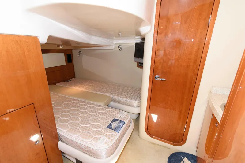 Slide: The Image of 2006 Regal 4460 Commodore cabin with twin beds and wooden interior. - 21