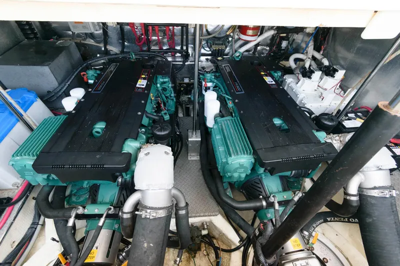 Slide: The Image of Engine room of a 2006 Regal 4460 Commodore yacht, featuring dual engines. - 24