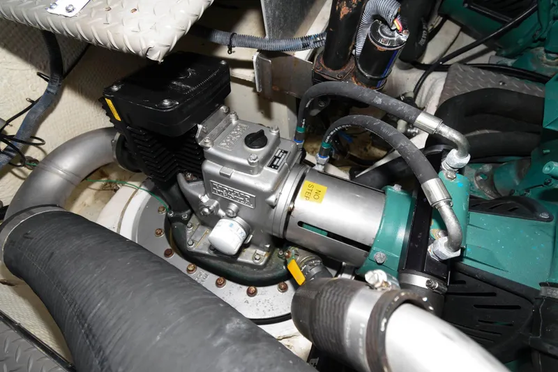 Slide: The Image of Engine compartment of a 2006 Regal 4460 Commodore boat, showcasing mechanical components and hoses. - 27