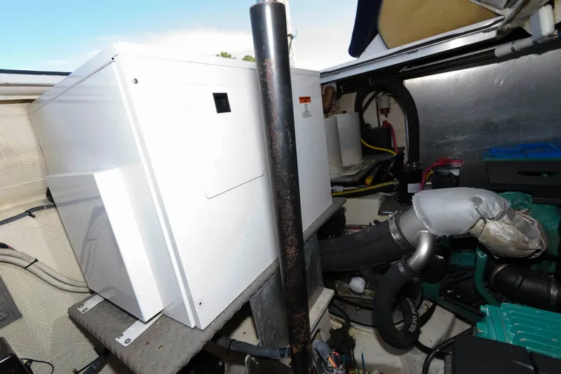 Slide: The Image of Engine room of 2006 Regal 4460 Commodore yacht, featuring mechanical components and equipment. - 29