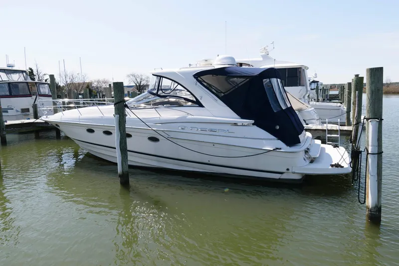 Slide: The Image of 2006 Regal 4460 Commodore yacht docked in marina, side view. - 3