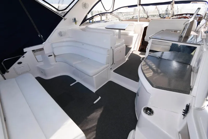 Slide: The Image of 2006 Regal 4460 Commodore yacht interior with white seating and modern amenities. - 4