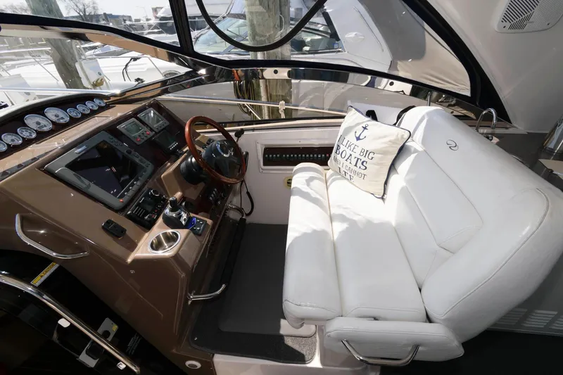 Slide: The Image of Helm of 2006 Regal 4460 Commodore with white seating and nautical decor. - 6