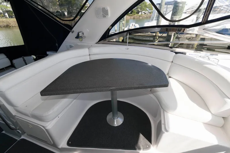 Slide: The Image of 2006 Regal 4460 Commodore yacht interior with white seating and a black table. - 9