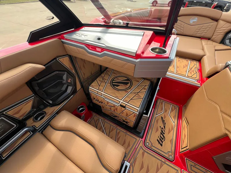 Slide: The Image of 2025 Tigé 25ZX Ultre' boat interior with tan seating and custom flooring design. - 19