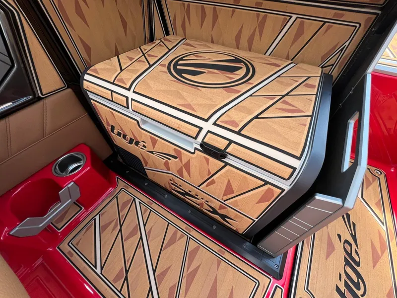 Slide: The Image of 2025 Tigé 25ZX Ultre' boat interior with custom wood-patterned design and red accents. - 20
