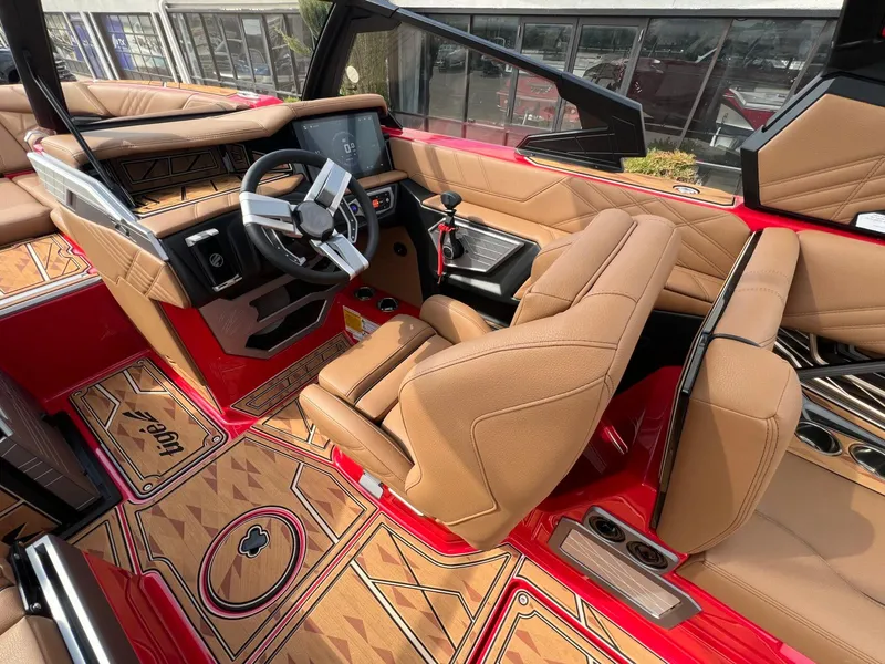 Slide: The Image of 2025 Tigé 25ZX Ultre' boat interior with tan seats and modern dashboard. - 22