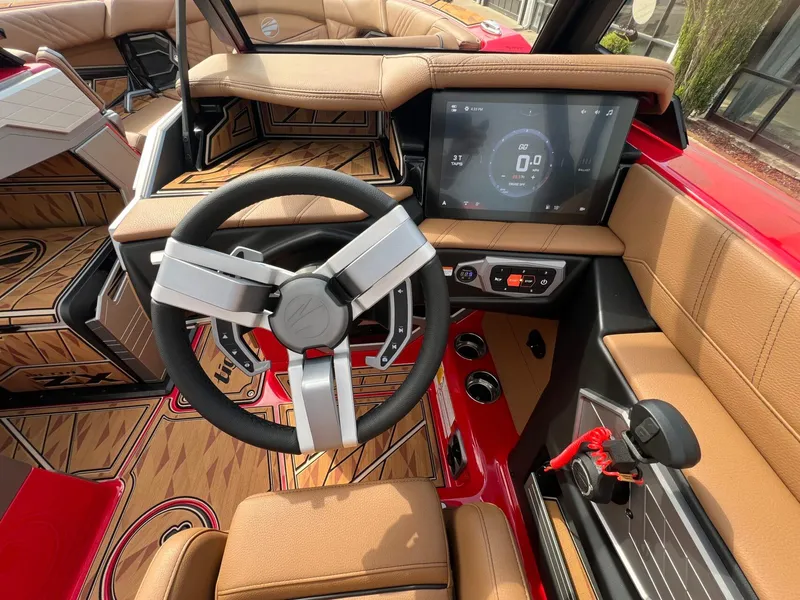 Slide: The Image of 2025 Tigé 25ZX Ultre' boat interior with modern steering wheel and touchscreen display. - 23