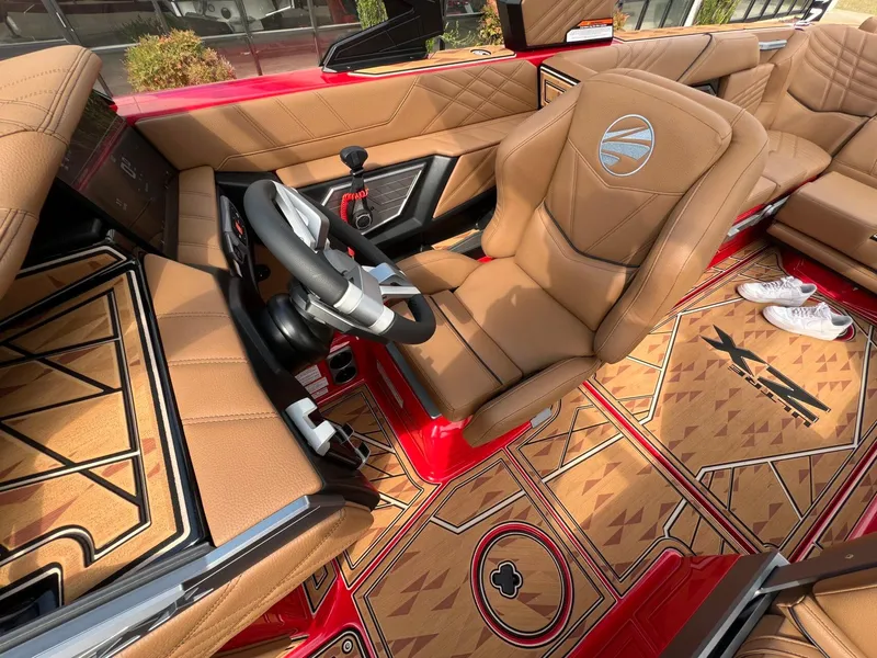Slide: The Image of Interior of 2025 Tigé 25ZX Ultre' boat with tan leather seats and stylish flooring. - 24