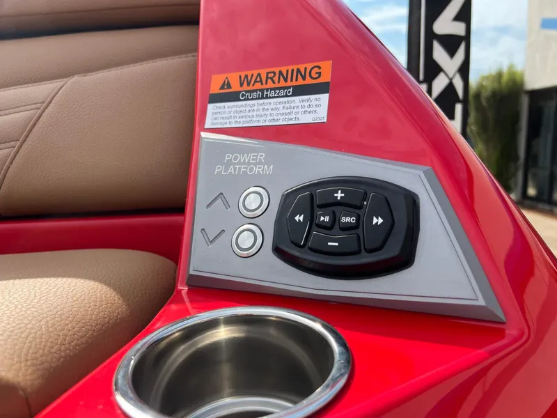 Slide: The Image of Control panel of 2025 Tigé 25ZX Ultre' boat with warning label and cup holder. - 7