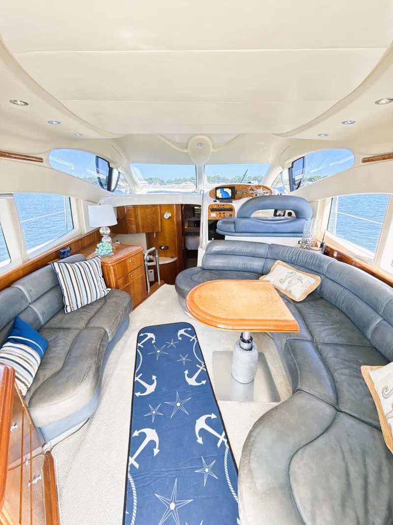 Slide: The Image of Luxurious interior of 2002 Azimut 42 yacht with elegant seating and nautical decor. - 11