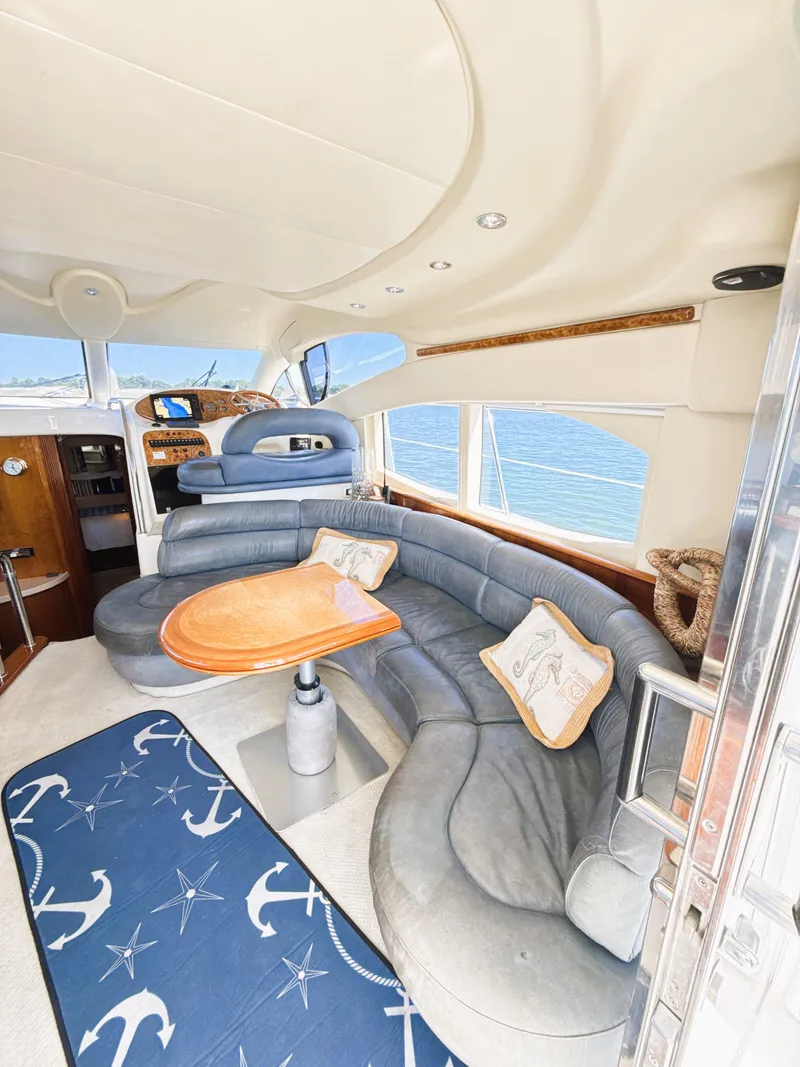 Slide: The Image of Luxurious 2002 Azimut 42 yacht interior with curved seating and nautical decor. - 12