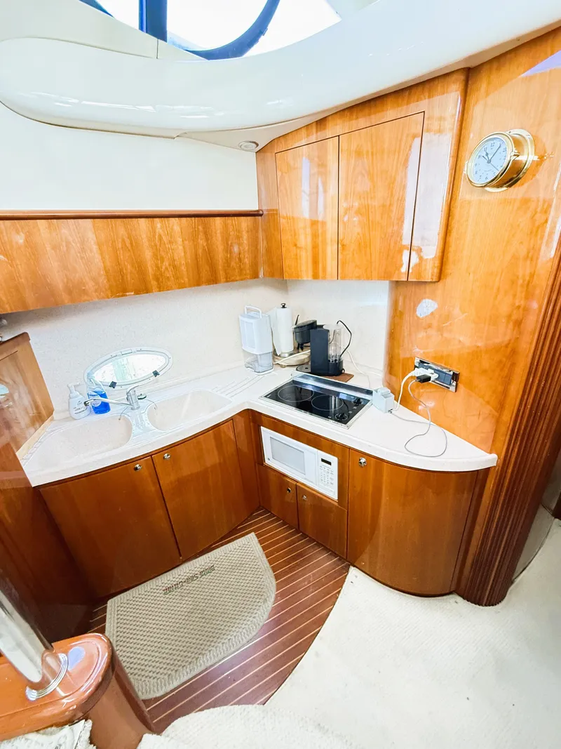 Slide: The Image of Luxurious 2002 Azimut 42 yacht kitchen with wood cabinetry and modern appliances. - 19