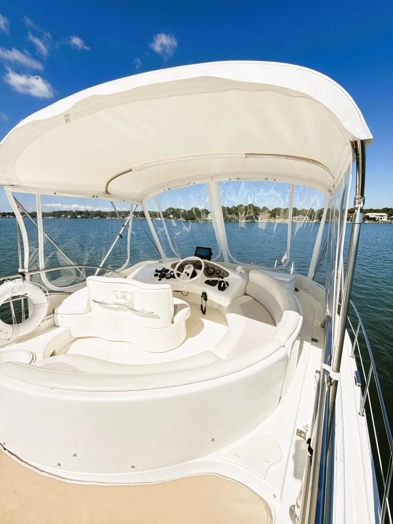 Slide: The Image of 2002 Azimut 42 yacht helm, featuring sleek design and open water view. - 23