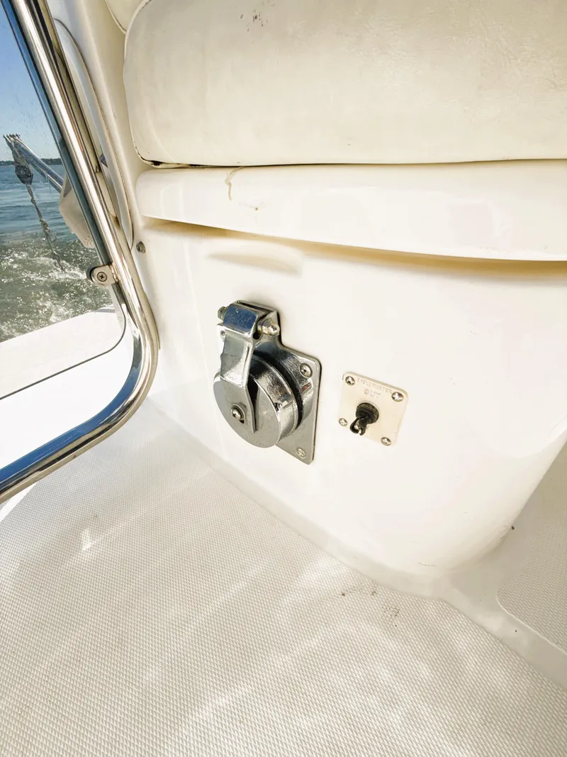 Slide: The Image of Interior detail of a 2002 Azimut 42 yacht, featuring a control panel and seating. - 36
