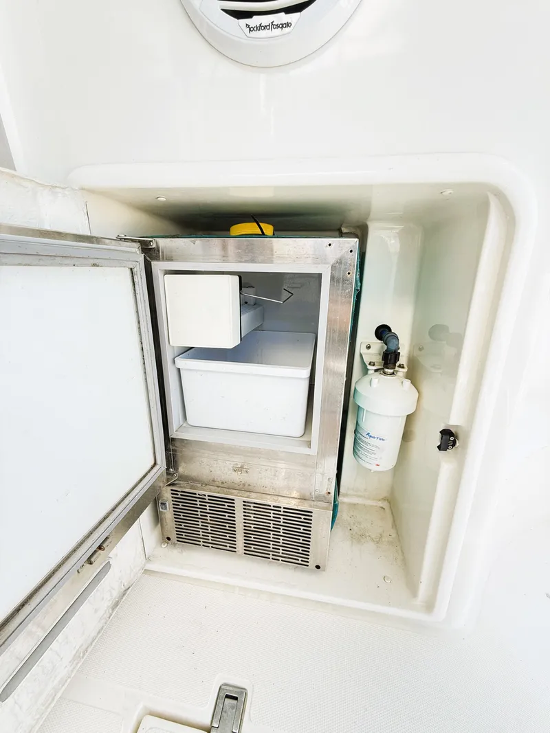 Slide: The Image of 2002 Azimut 42 yacht ice maker compartment with open door and visible filter. - 39