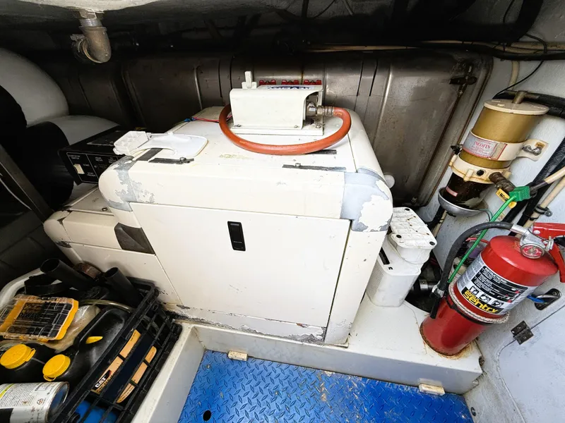 Slide: The Image of Engine room of 2002 Azimut 42 yacht with equipment and fire extinguisher. - 44