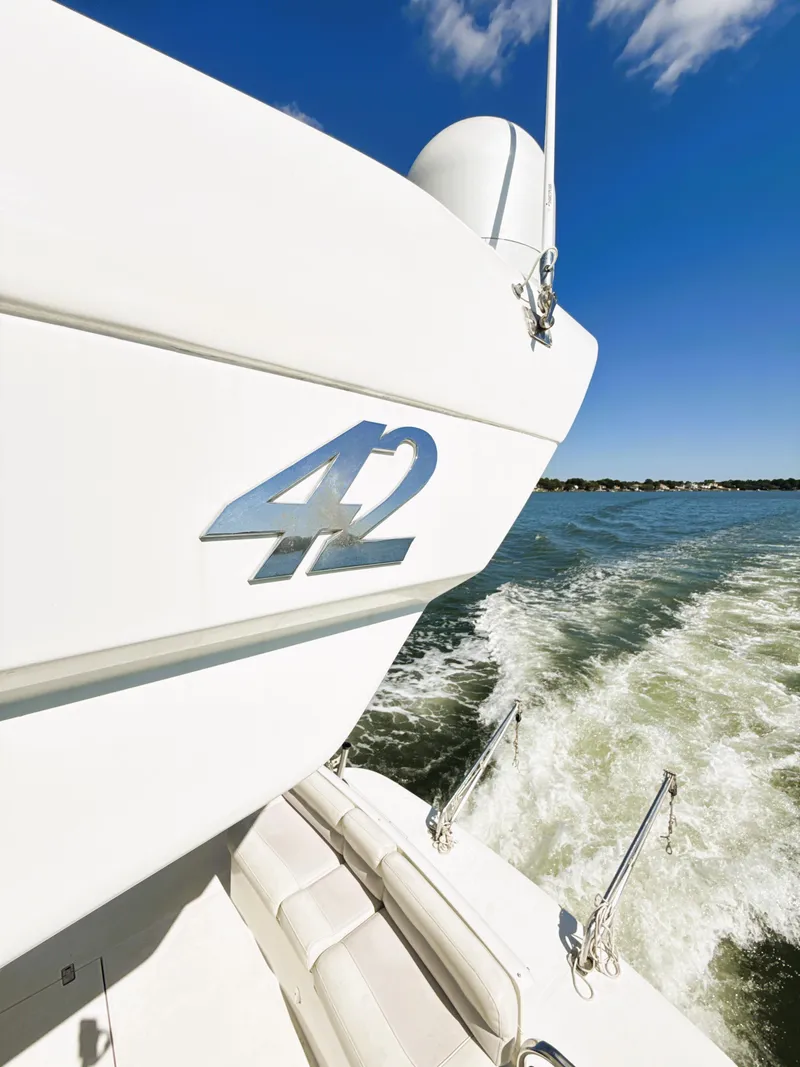 Slide: The Image of Azimut 42 yacht cruising on open water, 2002 model, clear blue sky. - 46